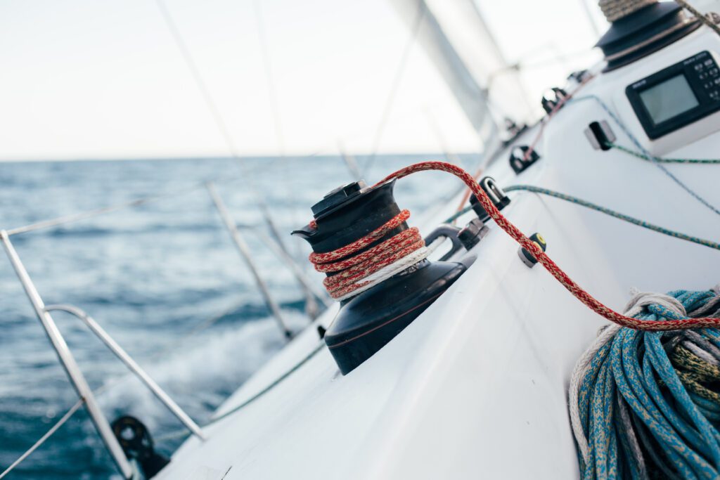 Winch on professional racing yacht leaning in wind